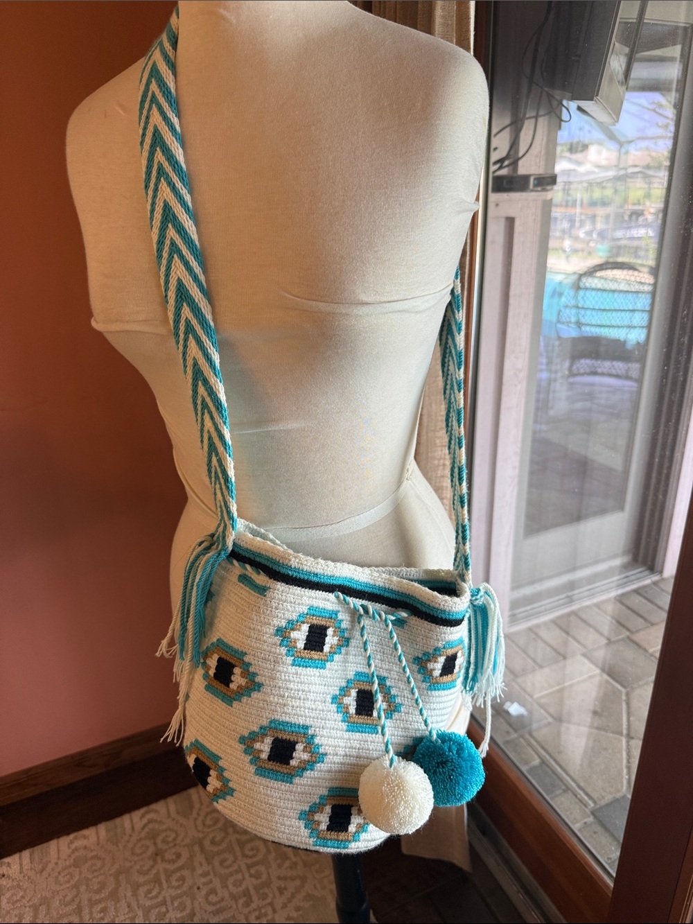 Handwoven Cream and Teal Crossbody Bag with Pom Pom Accents